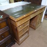 An Antique pine twin-pedestal writing desk, green leather skiver and fitted drawers, W122cm, H77cm