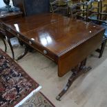 A Regency ebony-strung mahogany sofa table, with opposing drawers, raised on quadruple turned