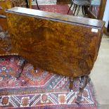 A Victorian figured walnut Sutherland table, with an inlaid marquetry top, raised on tapered columns