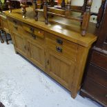A modern solid oak dresser base, with fitted short drawers and panelled cupboards, on stile legs,