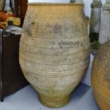 A large weathered terracotta 2-handled Cretan design oil jar, H110cm