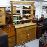 An Antique pine dresser, with open plate rack and cupboard fitted base, W138cm