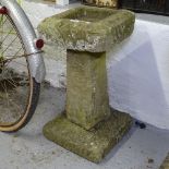 A weathered 3-section garden birdbath