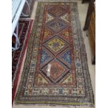 A red ground Caucasian design runner, 290cm x 110cm