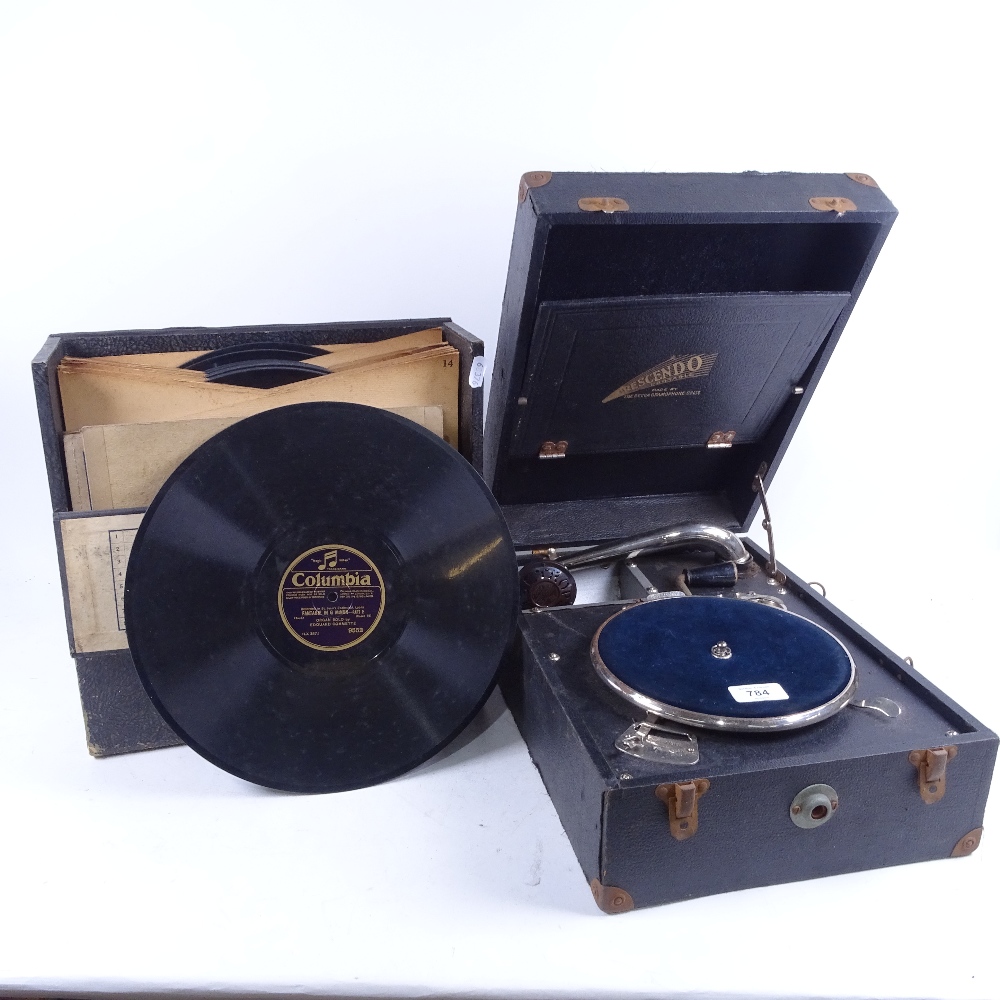 A Vintage Crescendo wind-up portable gramophone, and a selection of records
