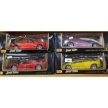 A collection of boxed Maisto sports cars, including Jaguar and Volkswagen Cabriolet