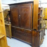 An 18th century mahogany linen press, the top converted to hanging space, on a drawer-fitted base,