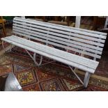 A Victorian hardwood slatted garden bench, on 3 scrolled wrought-iron legs, L250cm