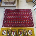A red ground Tekke design rug, 150cm x 100cm