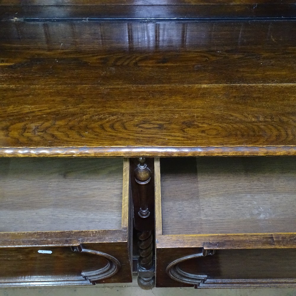 An oak 2-section dresser, the top fitted with fielded panelled cupboards and open shelves, 2 - Image 2 of 2