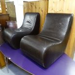 A pair of leather-upholstered slipper chairs