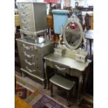 A decorative 4-piece bedroom suite, comprising dressing table with stool, a 4-drawer chest, and