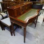 A reproduction mahogany lady's writing desk of serpentine form, with fitted drawers