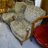 A pair of French walnut-framed and upholstered armchairs, with loose cushions, on carved cabriole