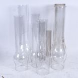 8 clear glass chimneys, of different sizes, for oil lamps
