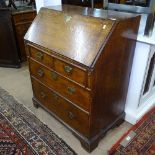 A Georgian oak bureau with fitted interior, 4 drawers under, on bracket feet, W76cm, H93cm