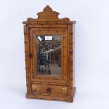 An early 20th century pine bamboo-effect table-top mirrored cabinet, upholstered interior with