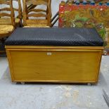 A polished pine-framed ottoman with upholstered seat, W92cm