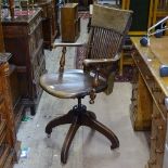 An early 20th century oak swivel desk chair