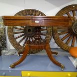 A Regency mahogany and ebony-strung fold over card table, on a turned centre column, and raised