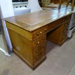 A Victorian oak twin-pedestal writing table, inset brown leather skiver, fitted drawers, W122cm,