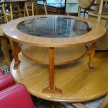 A mid-century teak circular 2-tier coffee table, with an inset smoked glass top, W86cm, H43cm