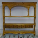 A hanging pine plate rack with spice drawers, W95cm