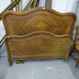 A French walnut panelled bed