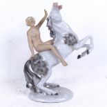 A German porcelain naked figure riding a horse, height 28cm