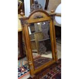 A Victorian walnut-framed arch-top wall mirror, with carved pediment and fluted pilasters, W70cm,