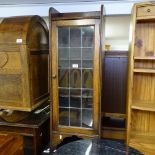 An Edwardian oak bookcase of narrow size, with glazed leadlight door, W36cm