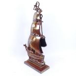 A copper and brass galleon design fireside tool set, framed height 61cm