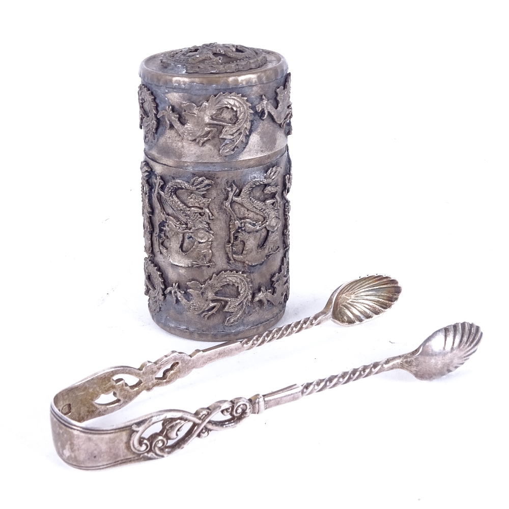 A pair of 19th century silver sugar nips, and a Chinese white metal cylindrical box and cover,