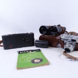 Leather-cased Hensoldt binoculars, a Voigtlander camera, and a Kodak leather-cased folding camera