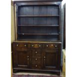 An Antique oak 2-section dresser, having a boarded open plate rack above 3 frieze drawers, with