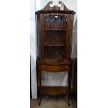 A late Victorian mahogany and satinwood-strung serpentine-front 2-section cabinet, the top having