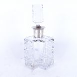 A stylised cut-glass scent bottle and stopper, with silver collar