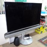 A Bang & Olufsen Beovision 7-55 flat screen TV with remote, on stand, type 7727, serial no.
