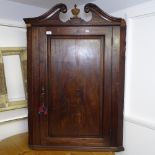 A Regency mahogany hanging corner cupboard, with single panelled door, W75cm