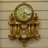 A modern German giltwood 8-day wall hanging clock, cream dial with Arabic numerals, and a pillar