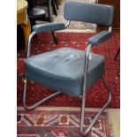 A mid-century modern tubular steel armchair with cantilever back