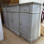 A painted pine breakfront sideboard, with 4 frieze drawers, fielded panelled cupboards under,