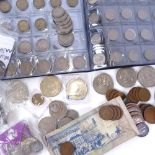A large quantity of various coins and banknotes, mostly British with some silver
