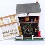 A handmade village shop design doll's house, containing various accessories, furniture, ornaments