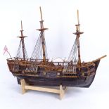 A handmade model ship, on stand, length 59cm, height 50cm