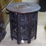 A Persian chip carved hardwood occasional table, on folding base, W45cm, H47cm