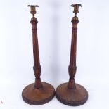 A large pair of carved mahogany table candlesticks with brass mounts, height 57cm