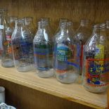 A shelf of 1980s advertising milk bottles, and dairy bottles