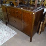 A 20th century Heals sideboard, with fitted drawers and cupboards, with button to inside of top