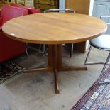 A mid-century Danish teak extending dining table, with 2 spare leaves